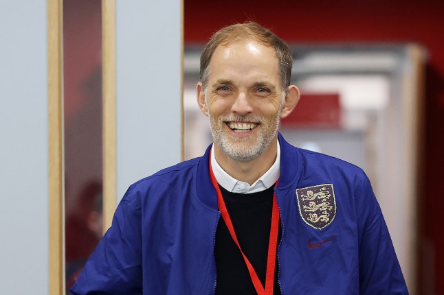England manager Thomas Tuchel smiling, wearing a blue Three Lions jacket on his first day.