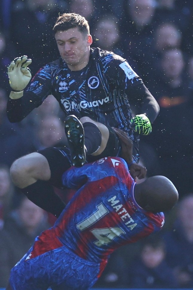 Crystal Palace's Jean-Philippe Mateta is fouled by Millwall goalkeeper Liam Roberts, for which he got a red card, during the English FA Cup soccer match between Crystal Palace and Millwall at Selhurst Park, London, England, Saturday, March 1, 2025. (AP Photo/Ian Walton)
