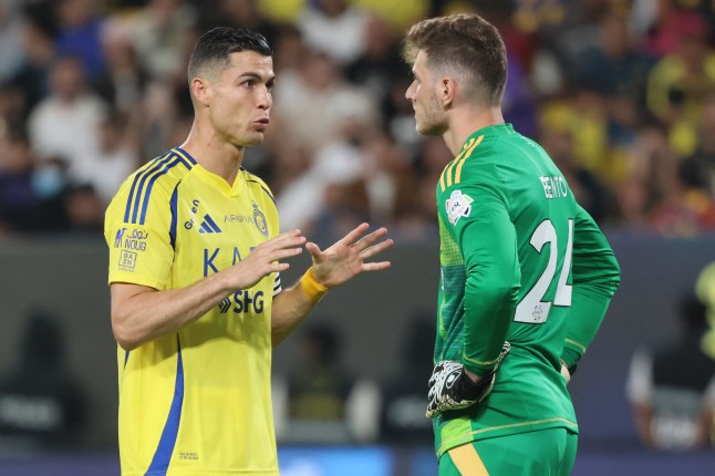 Nassr's Portuguese forward #7 Cristiano Ronaldo speaks to Nassr's Brazilian goalkeeper #24 Bento during the Saudi Pro League football match between Al-Nassr and Al-Shabab at Al-Awwal Park in Riyadh on March 7, 2025. (Photo by Fayez NURELDINE / AFP) (Photo by FAYEZ NURELDINE/AFP via Getty Images)