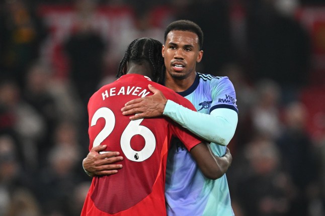 MANCHESTER, ENGLAND - MARCH 09: Ayden Heaven of Manchester United embraces Gabriel of Arsenal after the draw during the Premier League match between Manchester United FC and Arsenal FC at Old Trafford on March 09, 2025 in Manchester, England. (Photo by Stuart MacFarlane/Arsenal FC via Getty Images)
