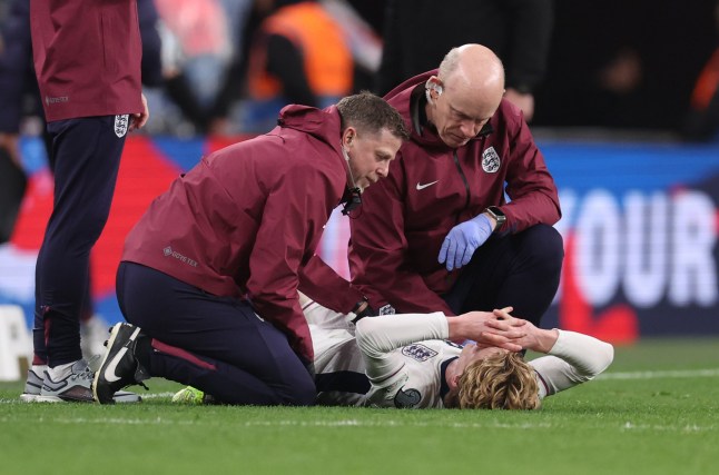 LONDON, ENGLAND - MARCH 21: Anthony Gordon of England is treated for an injury during the FIFA World Cup 2026 European Qualifier between England and Albania at Wembley Stadium on March 21, 2025 in London, England. (Photo by Catherine Ivill - AMA/Getty Images)